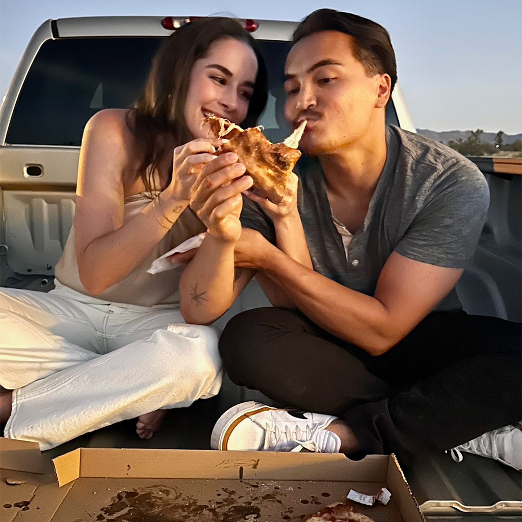 Clay and Alexa eating pizza in truckbed
